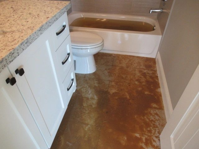 Bathroom floor conditions documented after the backup described in the article.