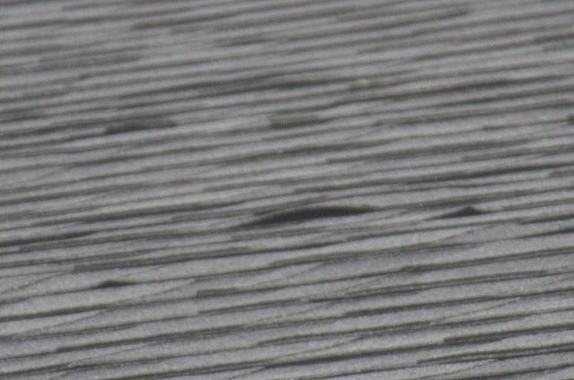Close-up of asphalt roof shingles inspected for installation concerns on a new construction home in Manvel, Texas
