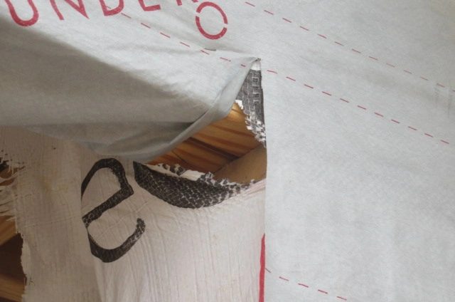 Close-up of the house wrap and exterior moisture barrier at the front entry of a new construction pre-sheetrock inspection in Manvel, Texas