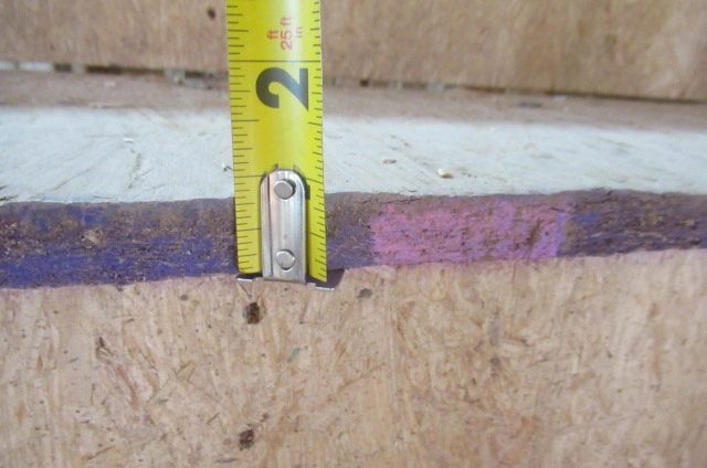 Close-up of a tape measure showing a stair construction measurement at a new home in Manvel, Texas, during a frame inspection by Brad Leland.