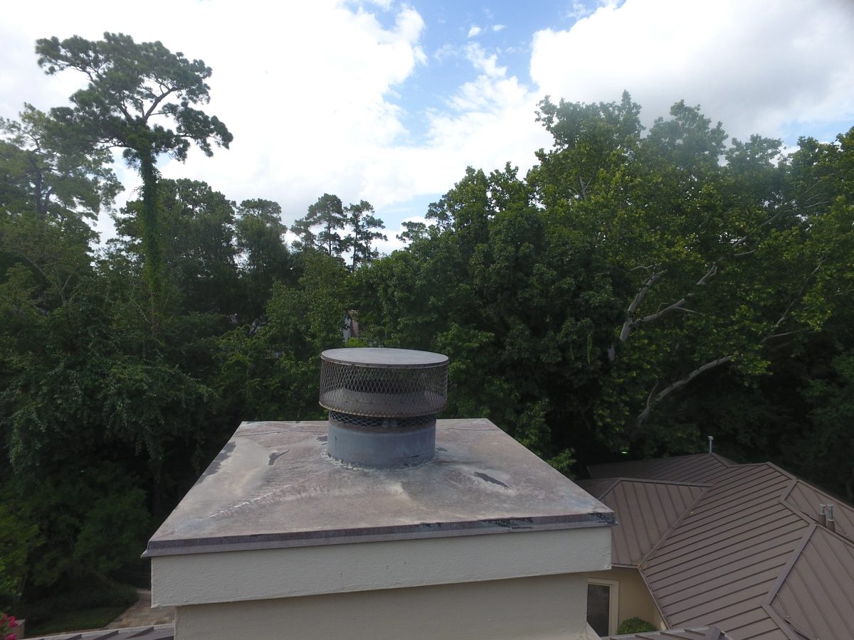 Chimney cap and flashing photographed from above during the inspection.