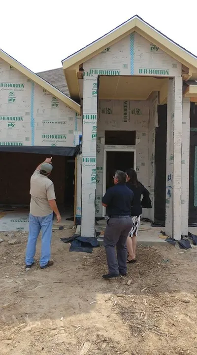 Brad discussing findings with clients during a frame-phase inspection in Pearland, Texas